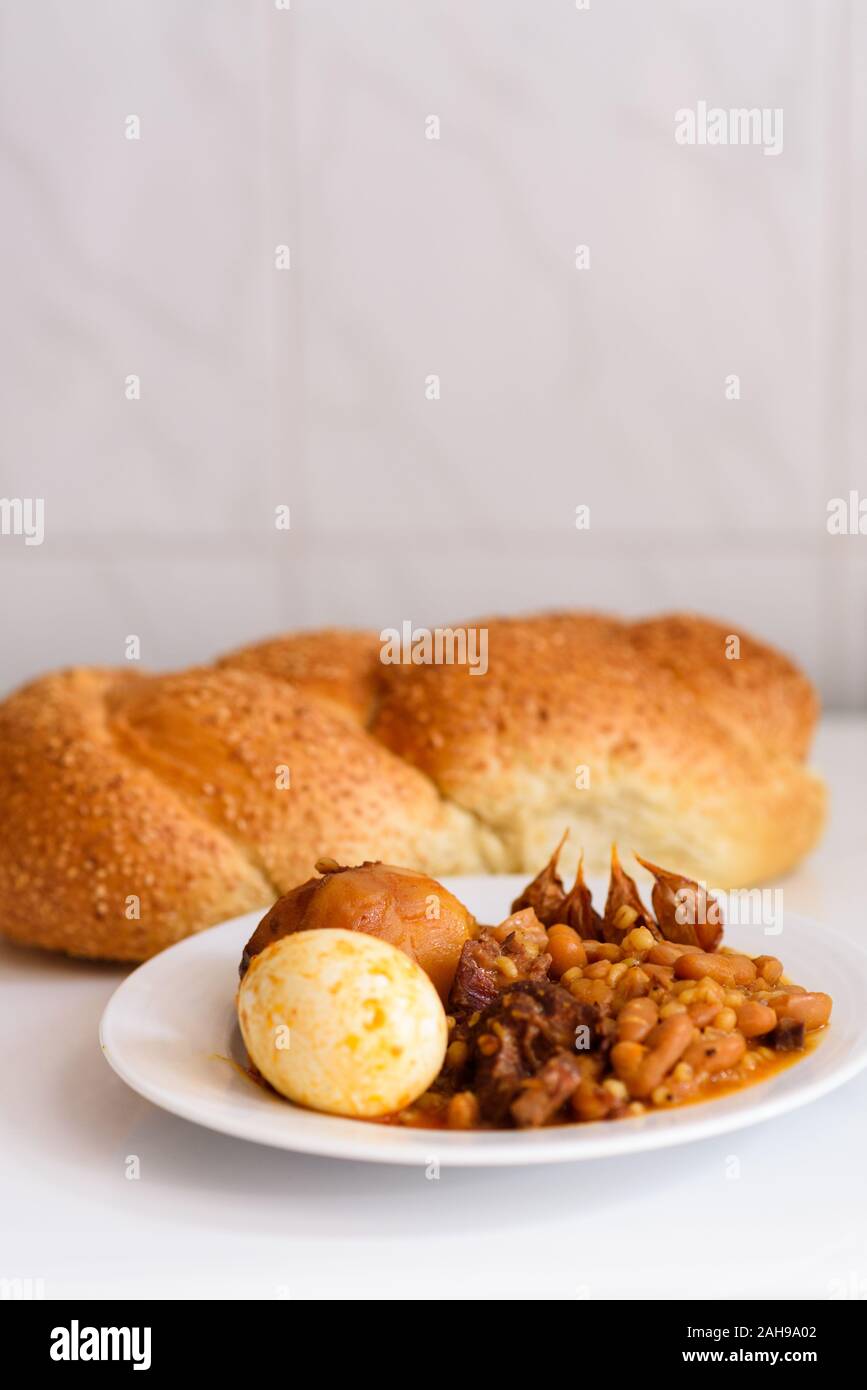 https://c8.alamy.com/comp/2AH9A02/challah-shabbat-bread-and-hamin-or-cholent-in-hebrew-sabbath-traditional-food-on-white-table-in-the-kitchen-2AH9A02.jpg