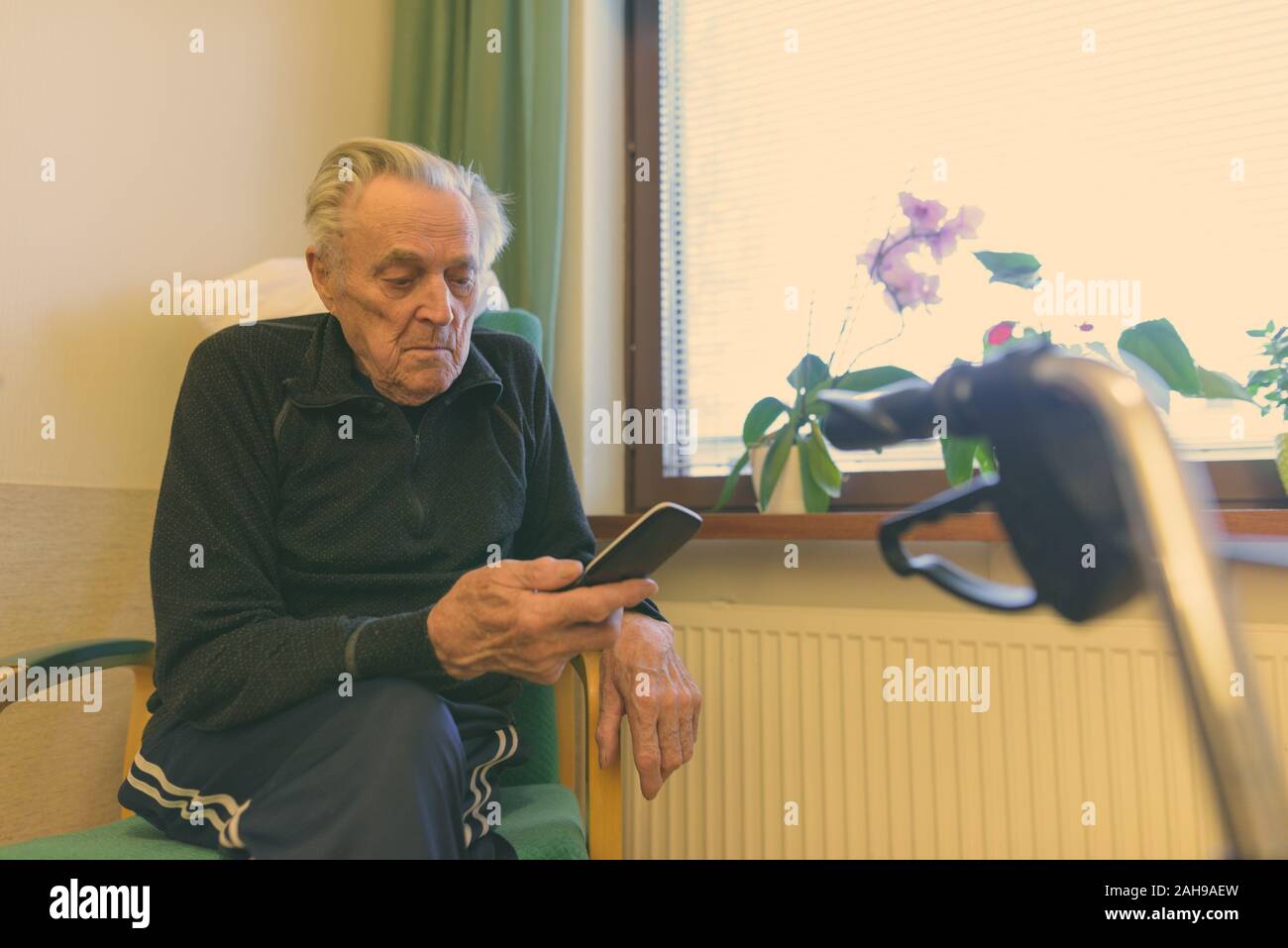 Senior man relaxing at nursing home in Turku, Finland Stock Photo