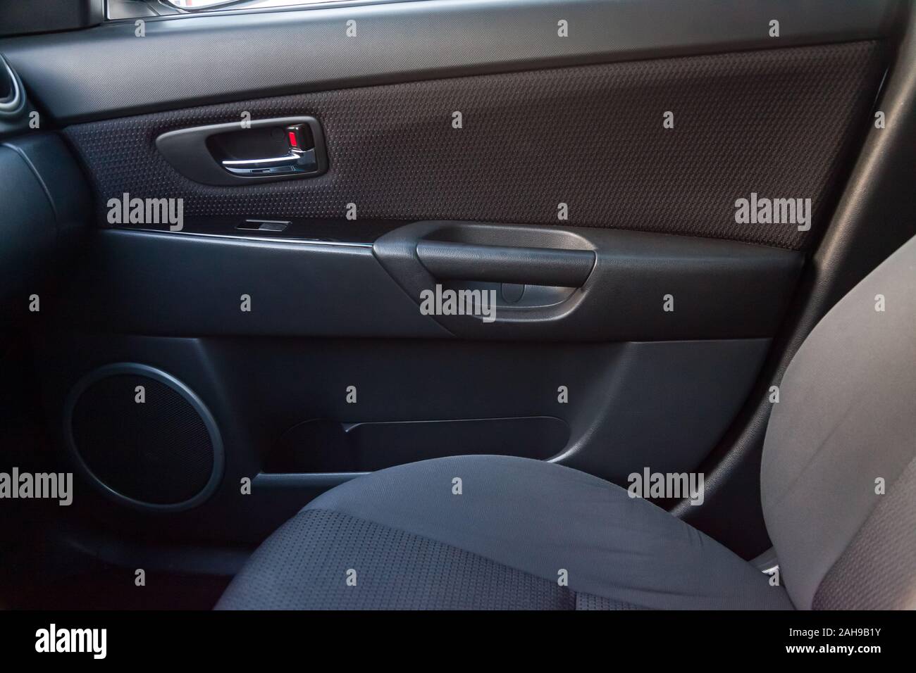The interior of the car with a view of the passengers door with buttons