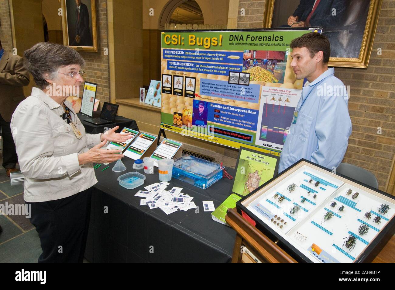 Ellen Mann (left), Library Technician, Special Collections, National Agricultural Library listens to Matt Lewis (right), Invasive Insect Biocontrol and Behavior Laboratory, Beltsville Agricultural Research Center explain how the lab set up the protocol for insects that are hard to identify at the Bed Bugs...Chocolate...and Beyond event held at the United States Department of Agriculture, Monday, October 4. The protocol is the first line of defense against invasive insect species and mice. Stock Photo