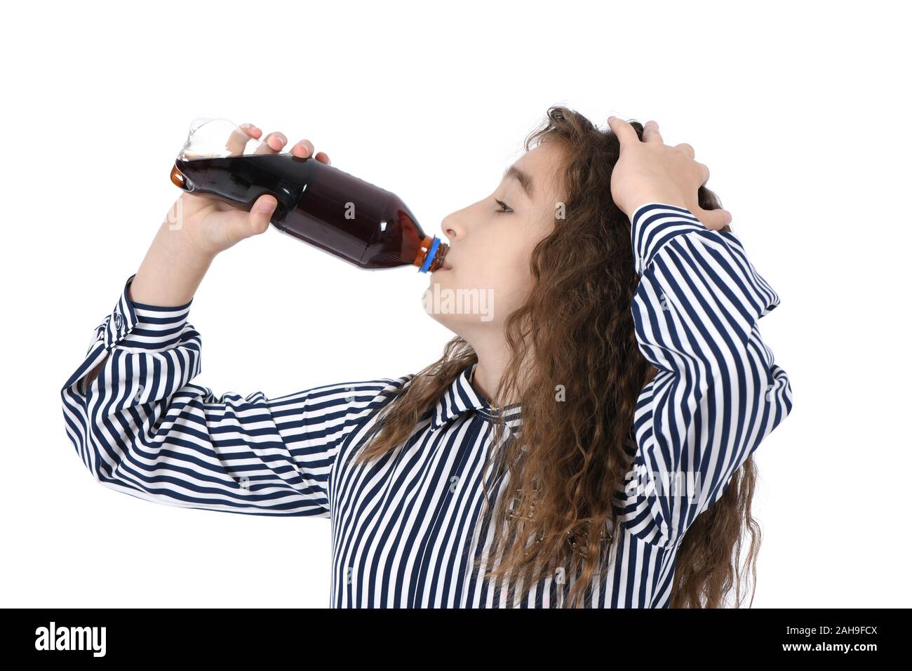 Child drinking Cola from bottle. On white background. High resolution photo. Full depth of field. Stock Photo
