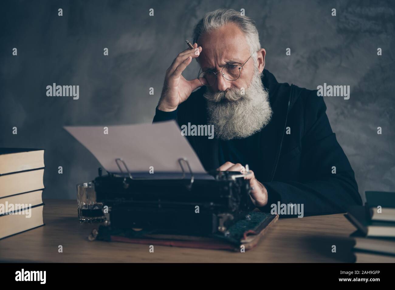 Close-up portrait of his he nice attractive focused bewildered bearded gray-haired professional creative publisher typing keyboard article essay diary Stock Photo