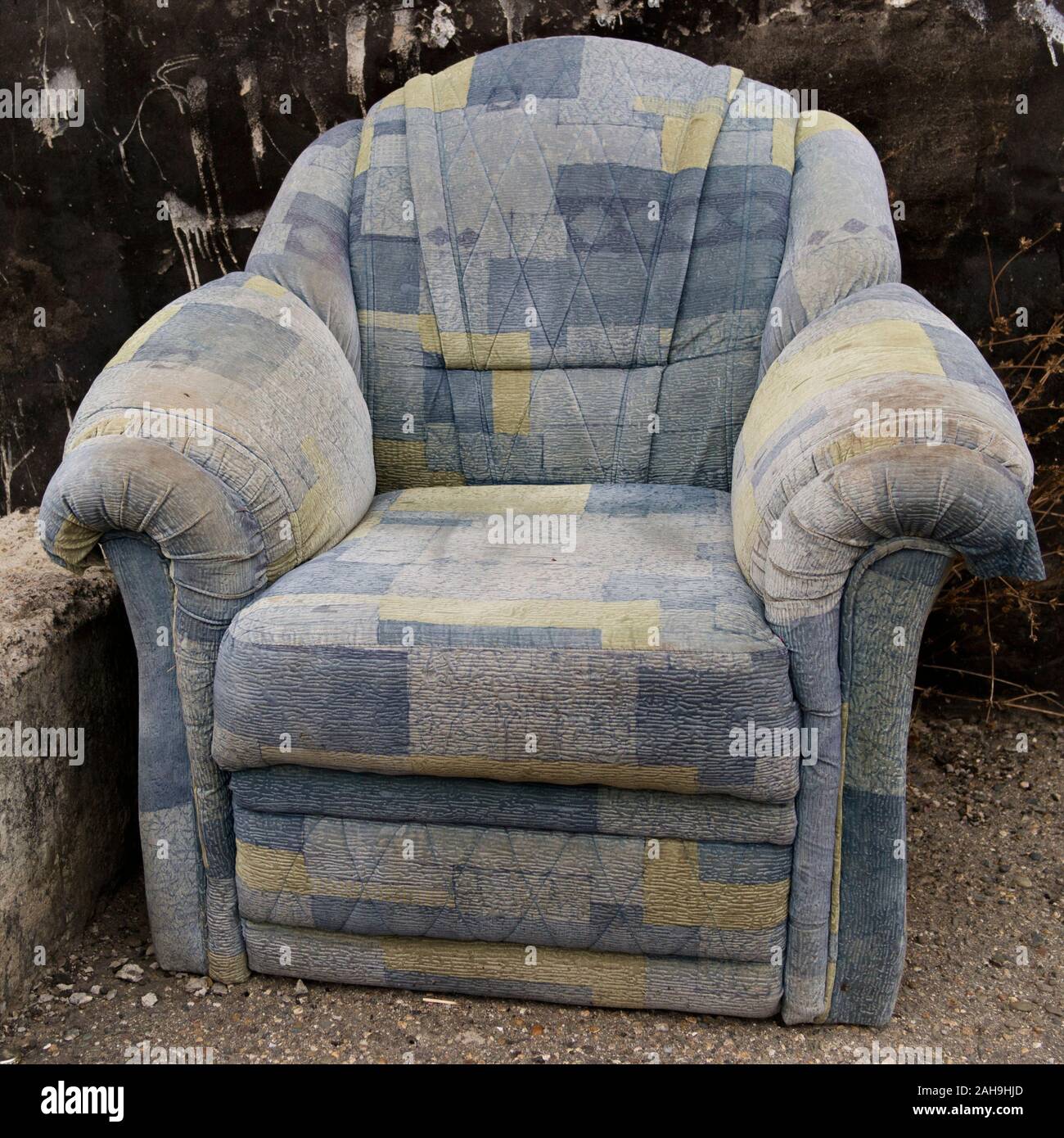 Old abandoned armchair. Blue armchair. Stock Photo