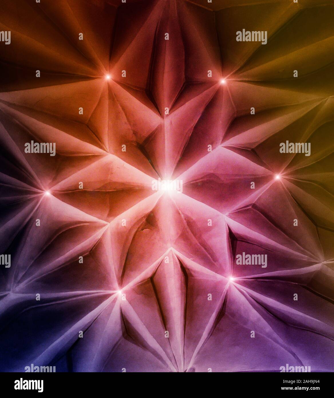 Digitally manipulated image of a fractal, hexagram star shaped medieval ceiling with bright lights at corners. Stock Photo