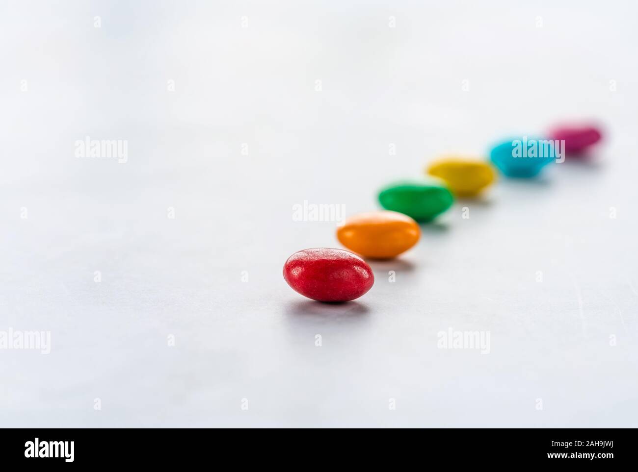 Colorful candy sweets on white background - closeup with selective ...