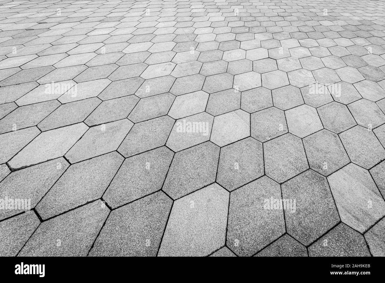 Top view on paving stone road. Old pavement of granite texture. Street