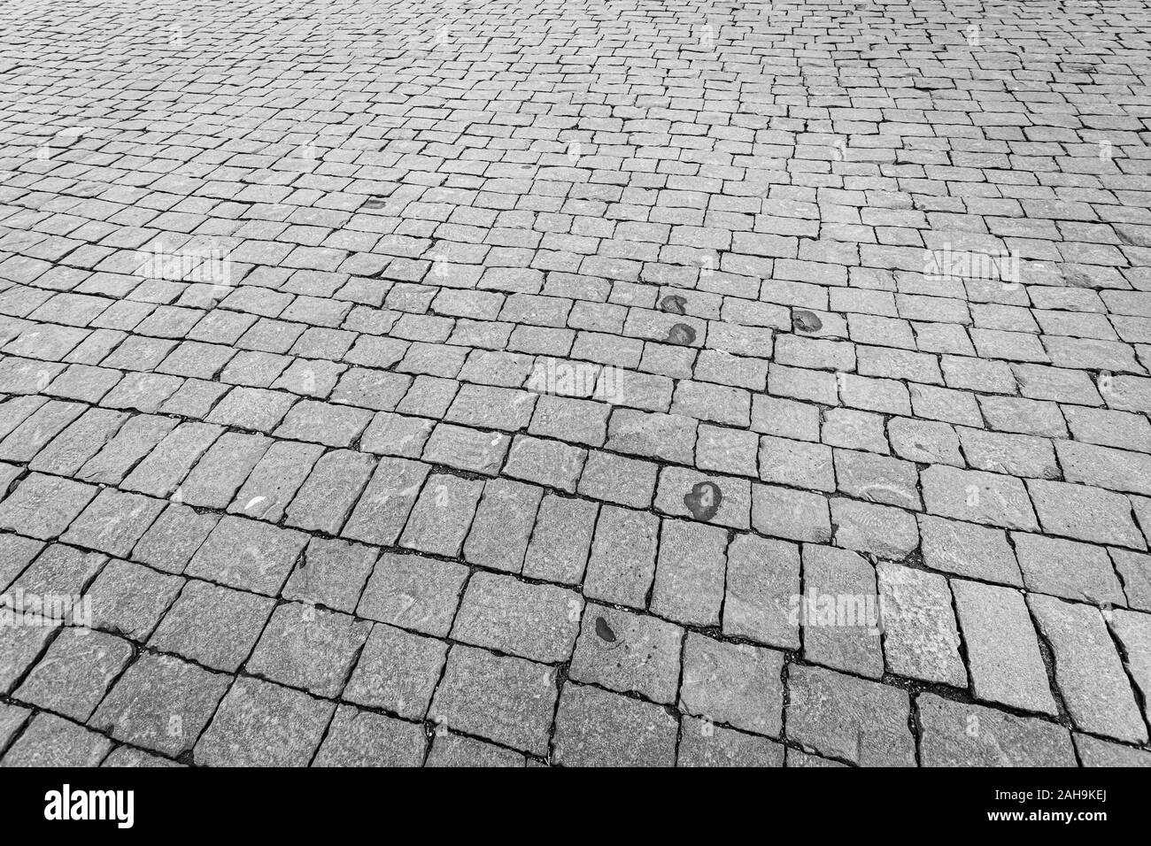 Top view on paving stone road. Old pavement of granite texture. Street