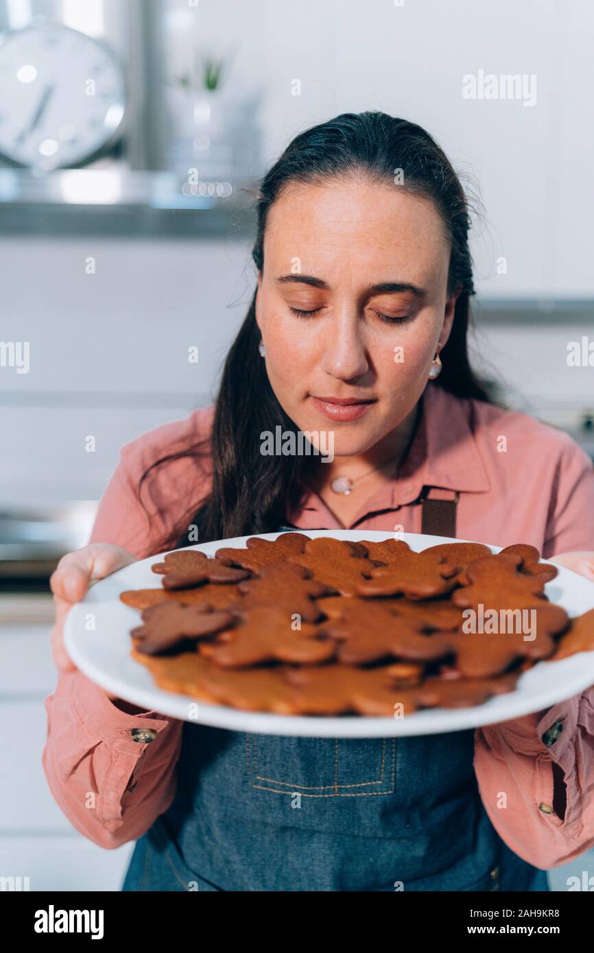 Woman smelling baked cookies hires stock photography and images Alamy