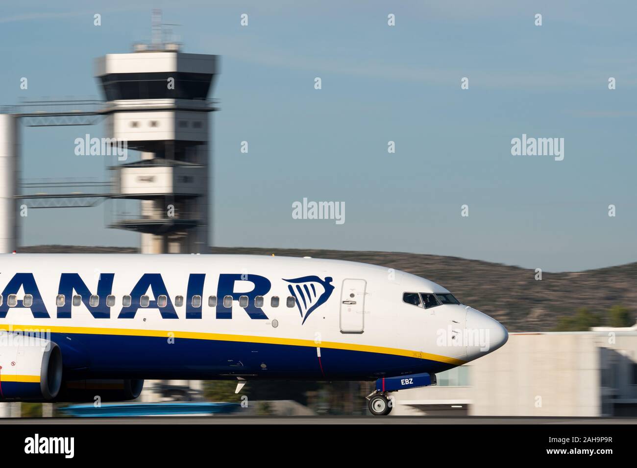 Ryanair plane landing panning with control tower in the background Stock Photo