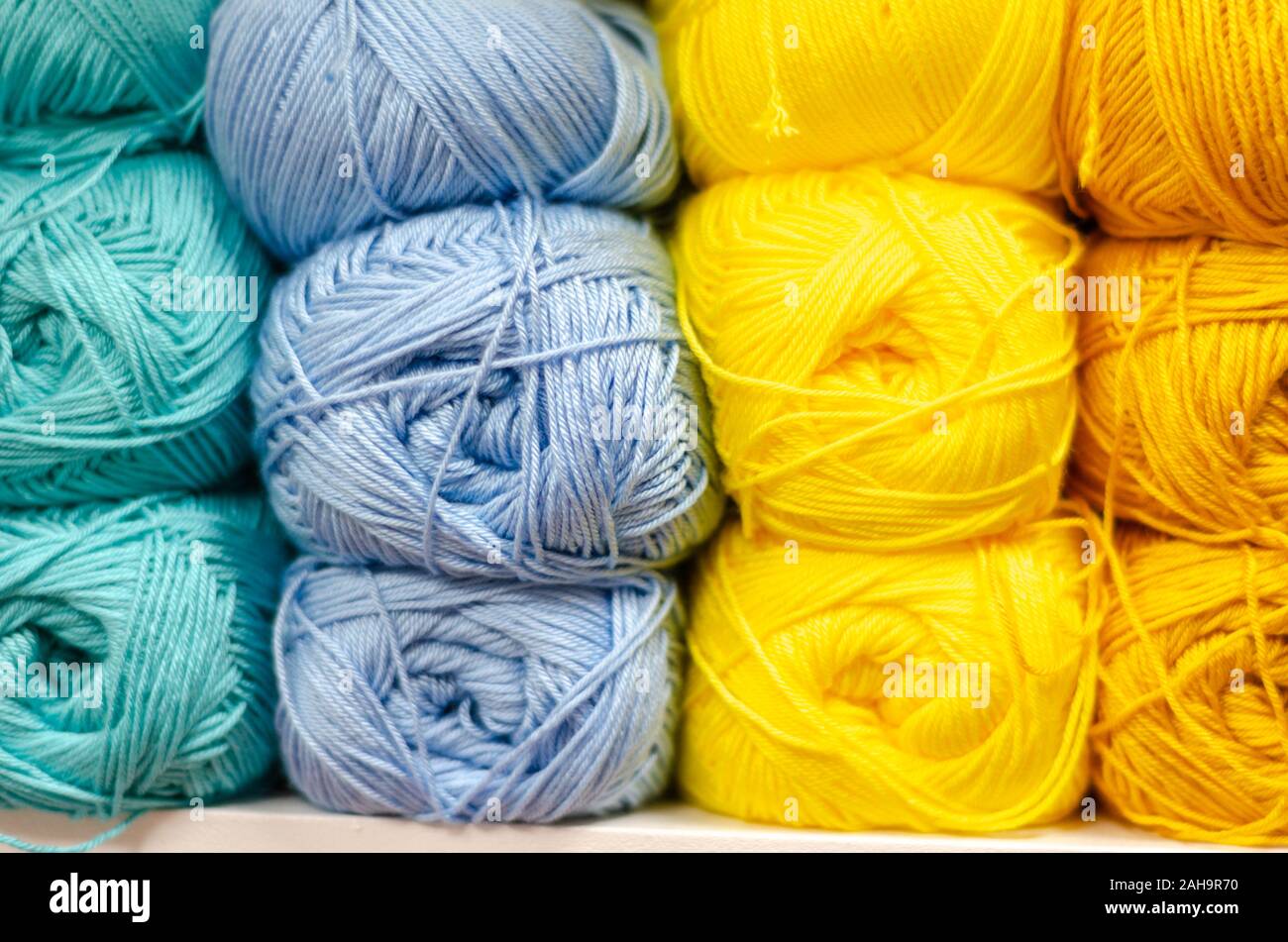 Colorful wool balls on shelf compartment in haberdashery Stock Photo