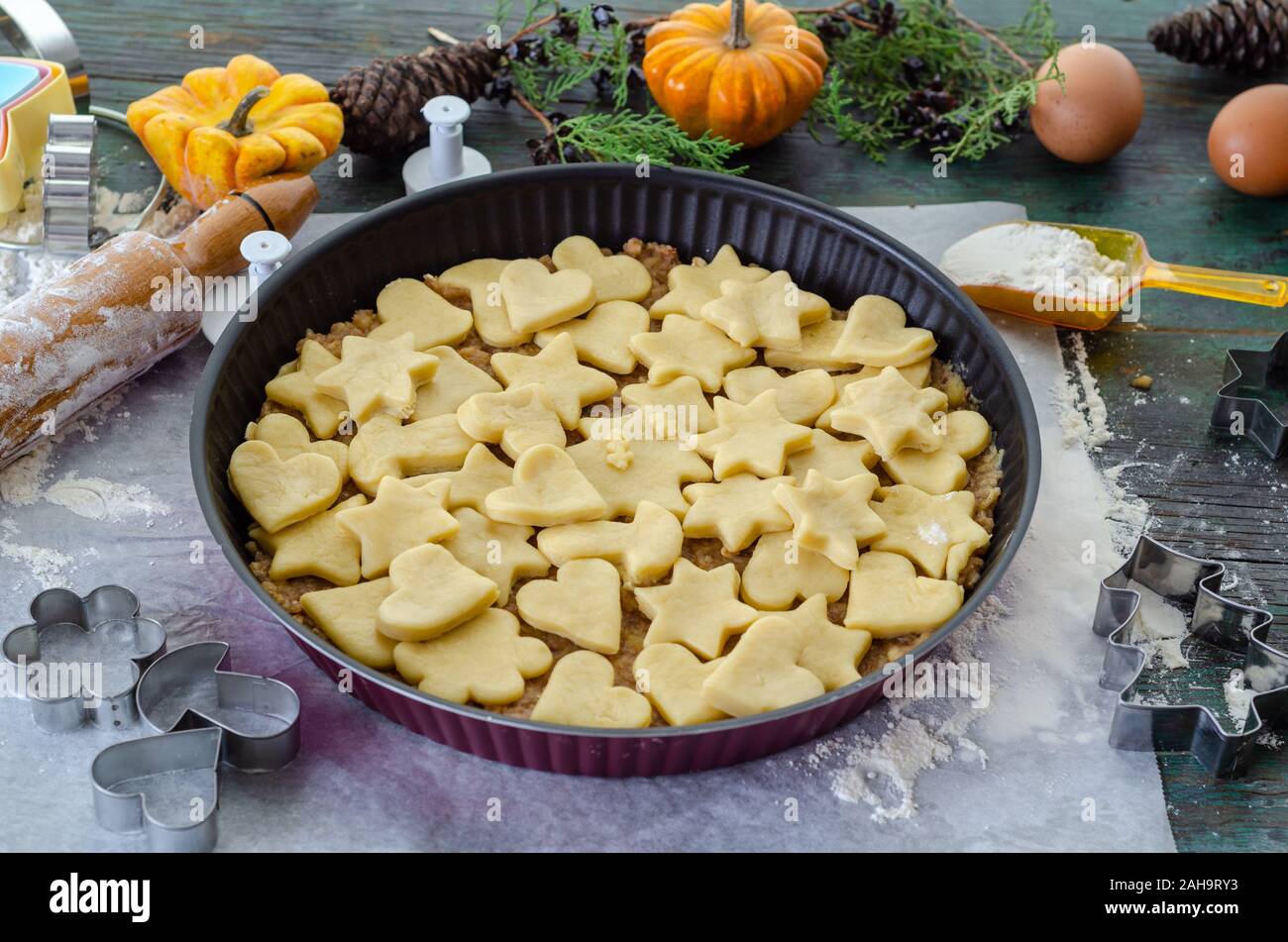 Apple pie ready to be baked in the oven, It  is covered with star and heart shaped cookies Stock Photo