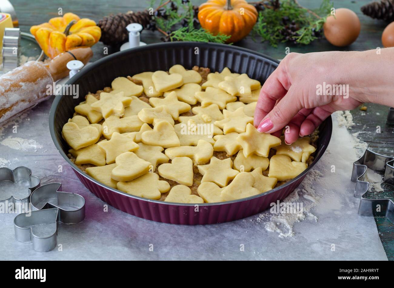 Apple pie ready to be baked in the oven, It  is covered with star and heart shaped cookies Stock Photo