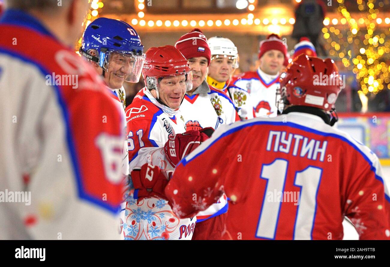 Russian President Vladimir Putin, #11, greets players during a friendly ice hockey match in the Night Hockey League at the GUM Department store ice rink in Red Square December 25, 2019 in Moscow, Russia. Stock Photo