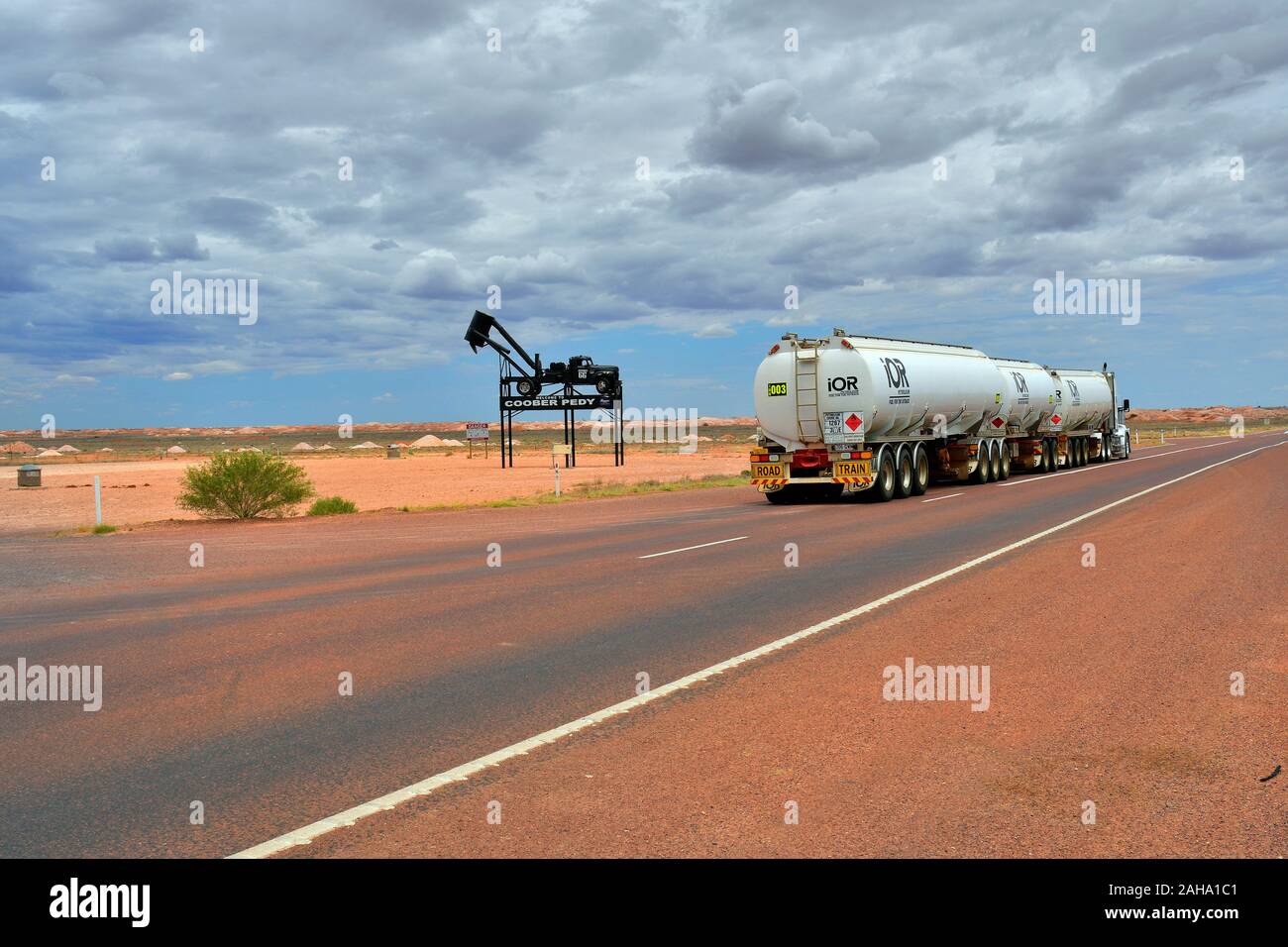 Coober Pedy, SA, Australia - November 13, 2017: Truck with three trailers named Road Train and landmark of Coober Pedy on Stuart Highway Stock Photo