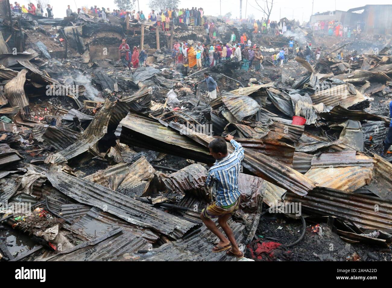 Dwellers at the fire devastated slum in Baunia badh area of Kalshi at Dhaka’s Mirpur.A fire gutted over 100 shanties at a slum in Baunia badh area of Kalshi at Dhaka’s Mirpur. Stock Photo