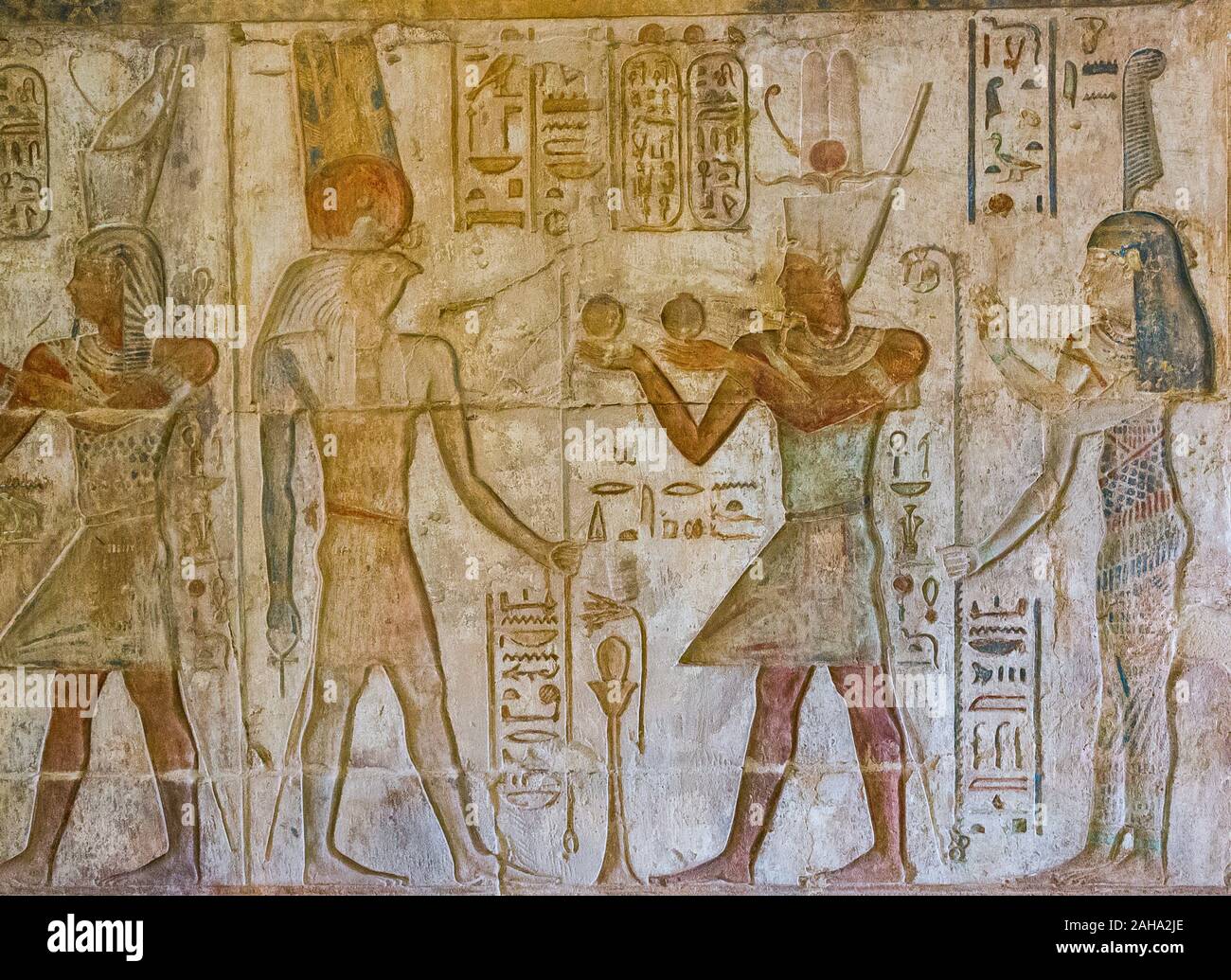 UNESCO World Heritage, Thebes in Egypt, ptolemaic temple of Deir el Medineh, devoted to Hathor. The king offers wine vases to god Monthu. Stock Photo