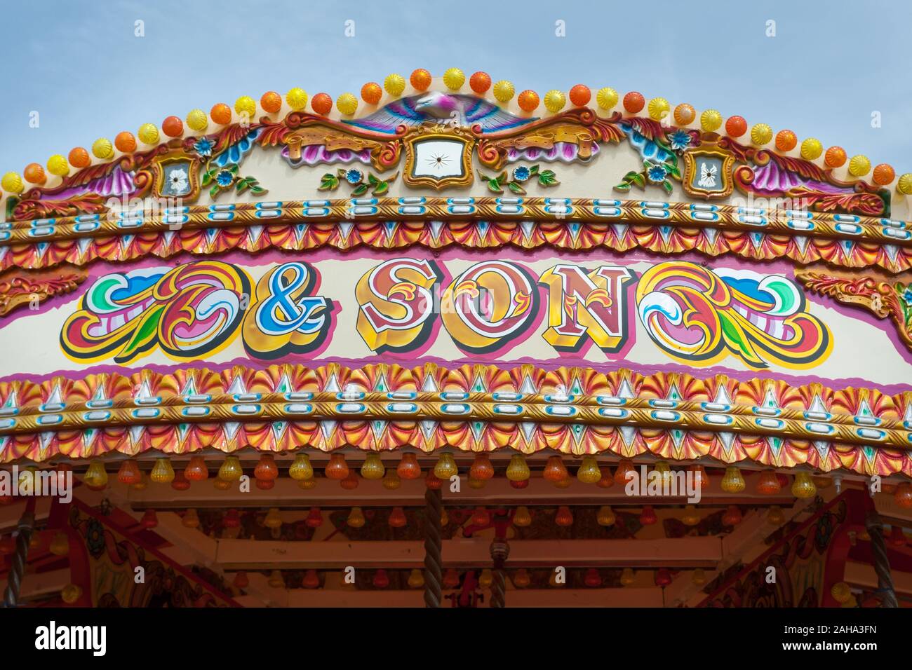 A traditional vintage carousel fairground ride, colourfully painted. Stock Photo
