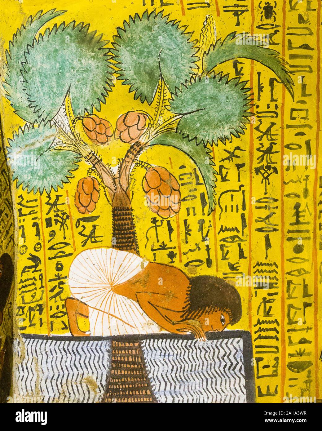 UNESCO World Heritage, Thebes in Egypt,  Deir el Medineh,  tomb of Irynefer, the Dead drinks water under a palm-tree. This painting helps to survive. Stock Photo