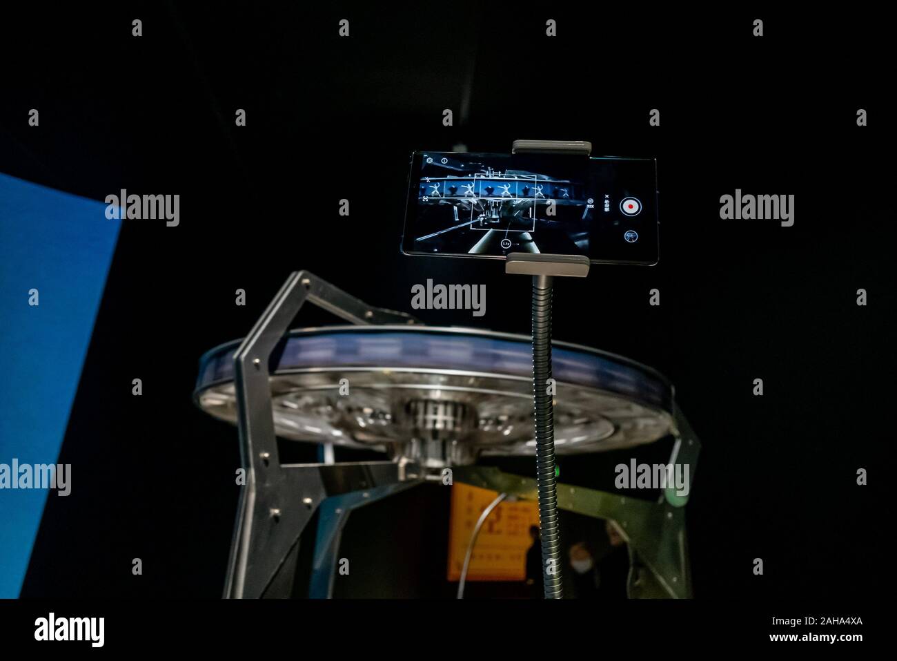 View of a Huawei smartphone capturing a revolving slide installation to