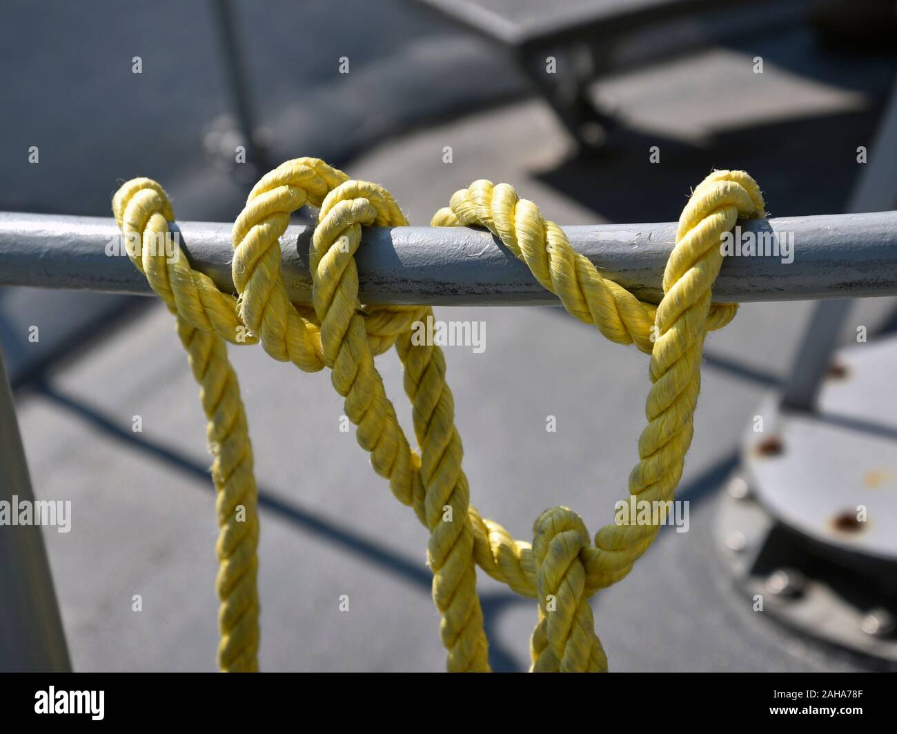 Yellow rope and node on a deck of ship Stock Photo - Alamy