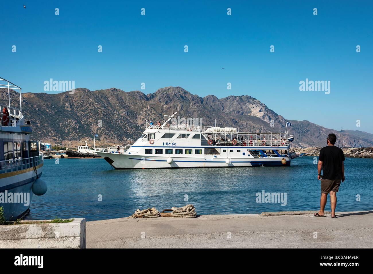 GREECE, KOS - MAY 31: Kardamena is a small town on the south coast of Kos and has all the makings of a great beach holiday. Passenger ship coming to t Stock Photo