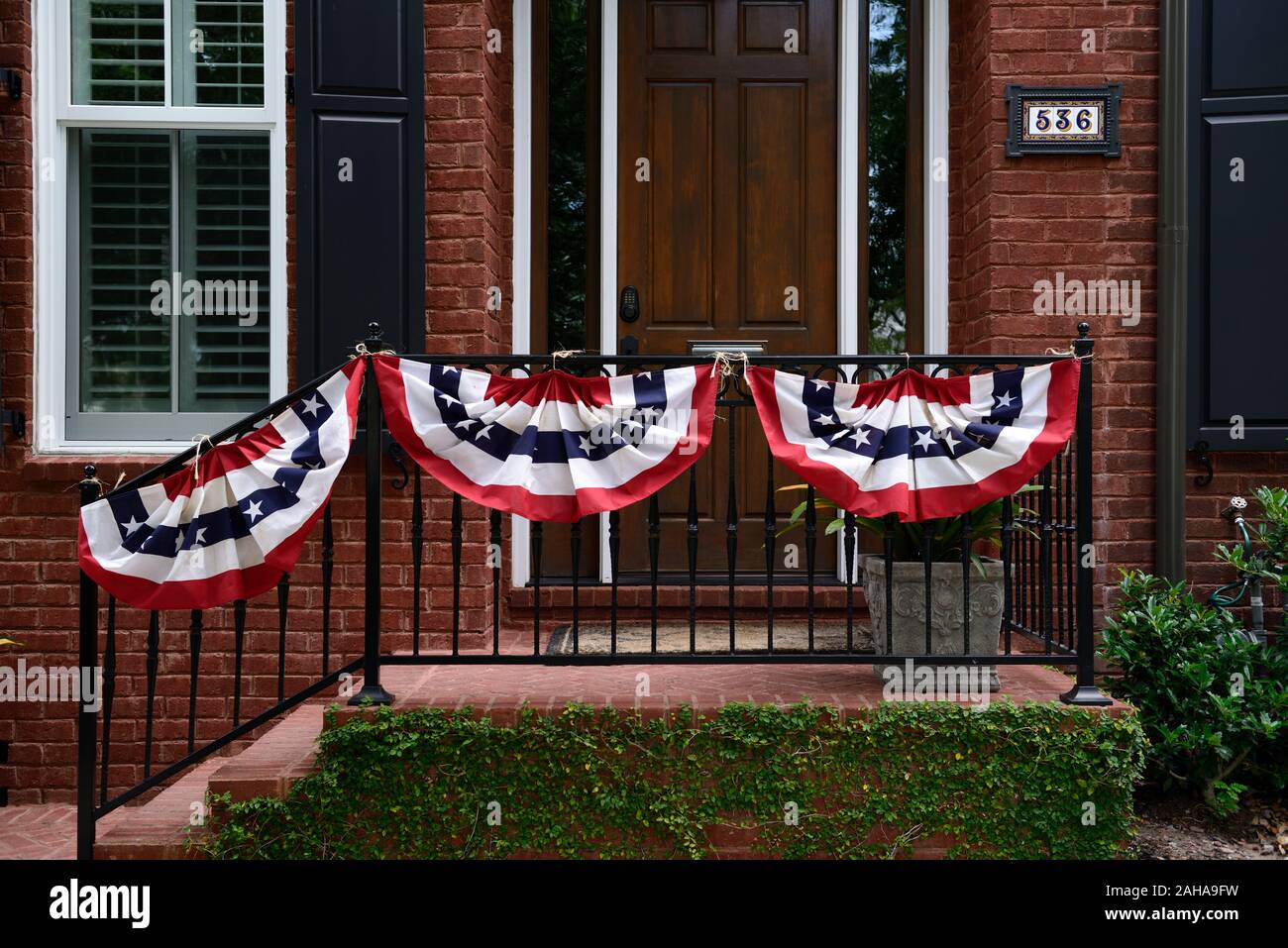 memorial weekend flags,banners,banner,flag,display,displays,rememberance,memory,tribute,tributes,savannah,georgia,house,railing,doorway,entrance,RM US Stock Photo