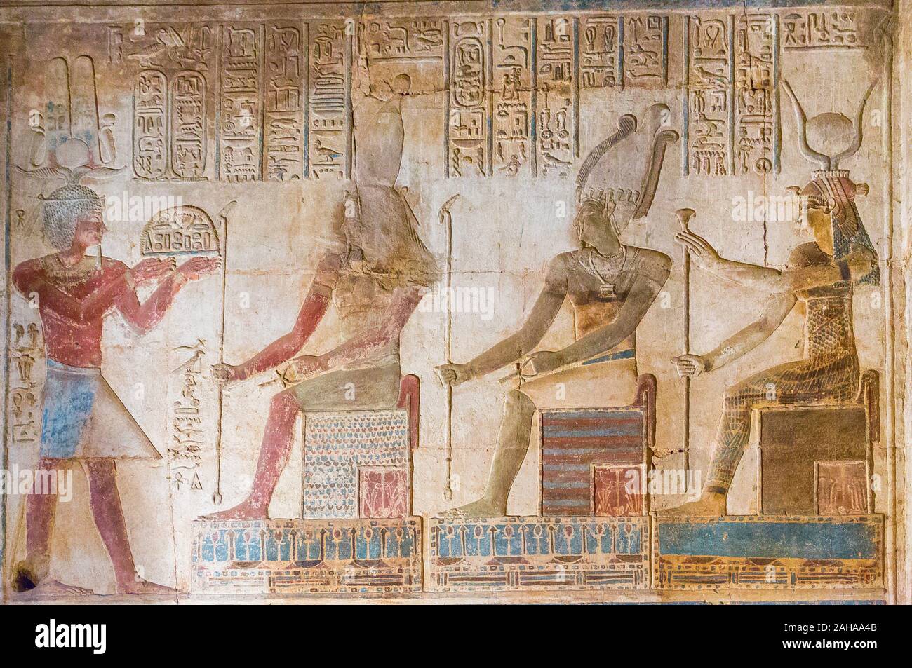 UNESCO World Heritage, Thebes in Egypt, Karnak site, ptolemaic temple of Opet. The king offers food to gods Geb, Osiris-Ounnefer and goddess Nut. Stock Photo