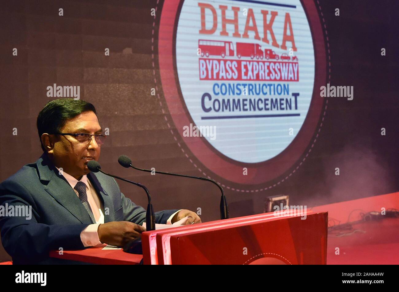 (191227) -- DHAKA, Dec. 27, 2019 (Xinhua) -- Md. Nazrul Islam, secretary of Road Transport and Highways Division of Bangladeshi Ministry of Road Transport and Bridges, speaks at the commencement ceremony of a mega expressway bypassing Dhaka in Bangladesh, Dec. 26, 2019. A Chinese and Bangladeshi joint venture has started construction of the mega expressway bypassing Dhaka. Sichuan Road and Bridge (group) Co., Ltd won the deal jointly with local Unique Dream Consultant and Shamim Enterprise Limited to construct the 48-km Dhaka Bypass Expressway. The expressway will pave the way for vehic Stock Photo