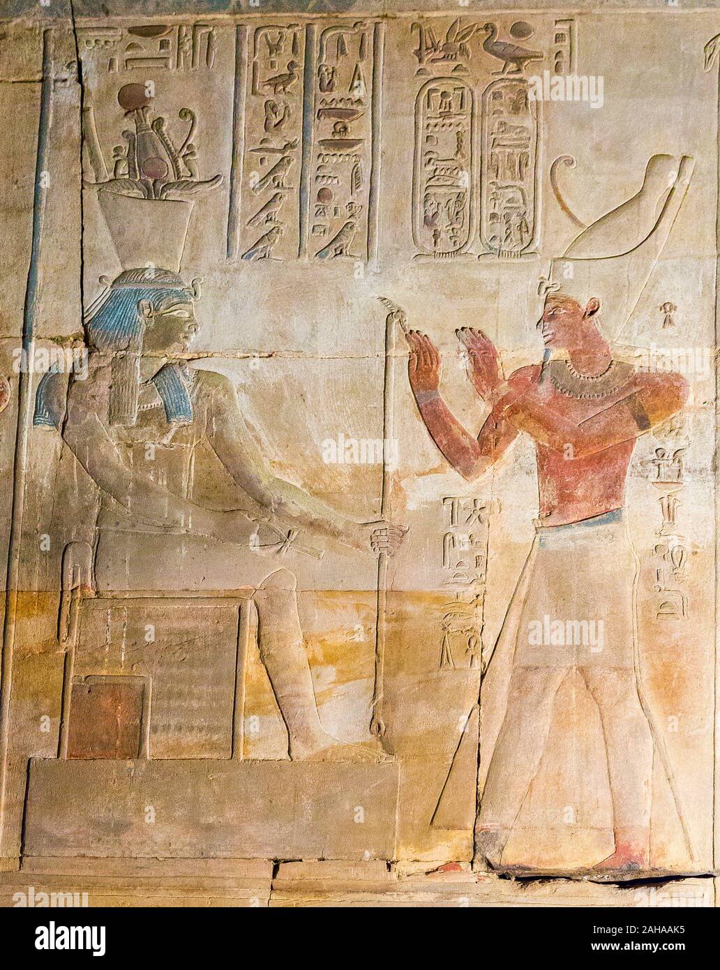 UNESCO World Heritage, Thebes in Egypt, Karnak site, ptolemaic temple of Opet. The king  prays god Geb seated on a throne and wearing a Shuti crown. Stock Photo