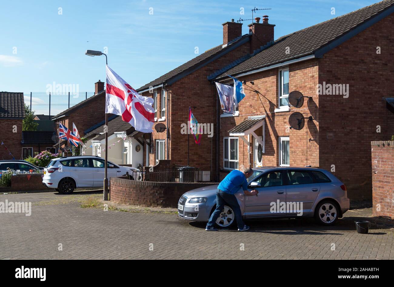 14.07.2019, Belfast, Northern Ireland, Great Britain - Protestant part of West Belfast, Union Jacks and Ulster flags from Orangemens Day at Ashmore Pl Stock Photo