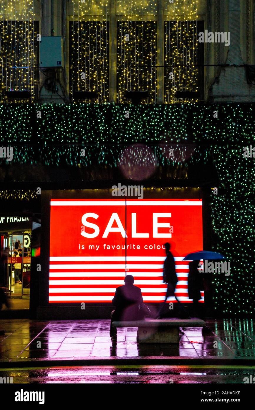 A large illuminated sale sign on Oxford Street during Christmas sales