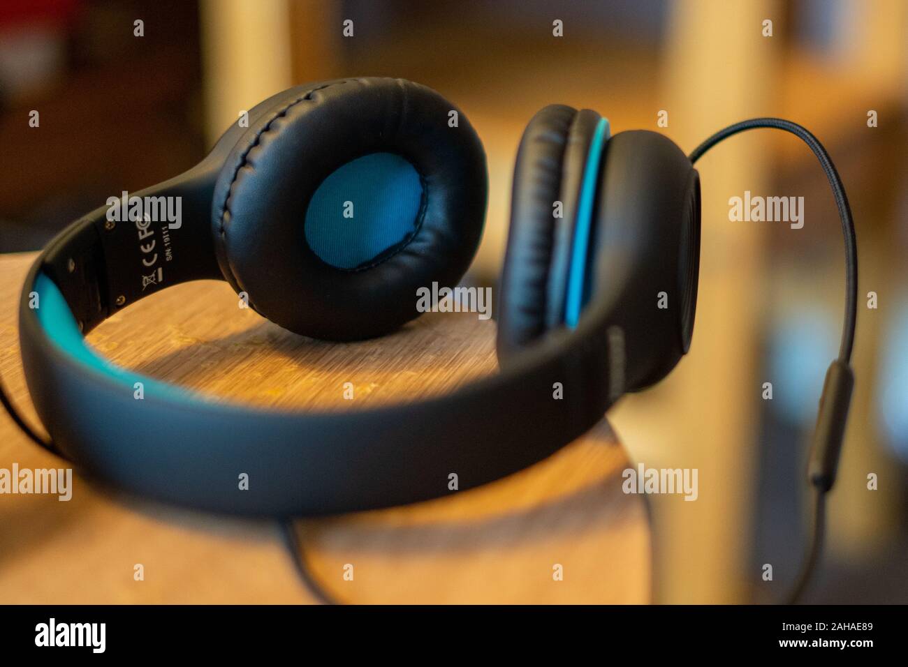 A pair over ear headphones on a table, child's headphones Stock Photo