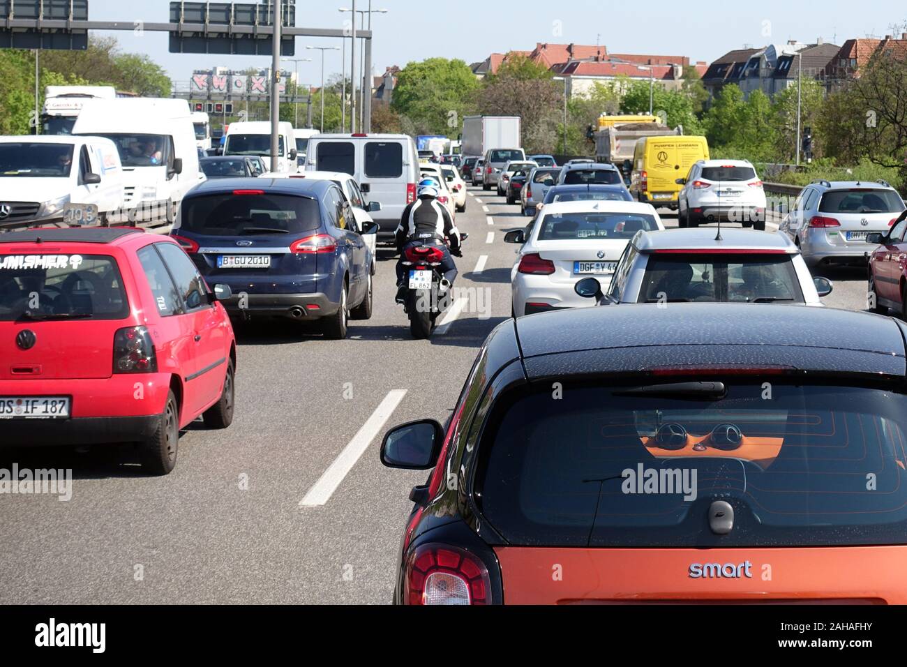 20.04.2018, Berlin, Berlin, Germany - Motorcyclists pushing their way past stationary cars in a traffic jam on the A100 towards the south. 00S180420D3 Stock Photo
