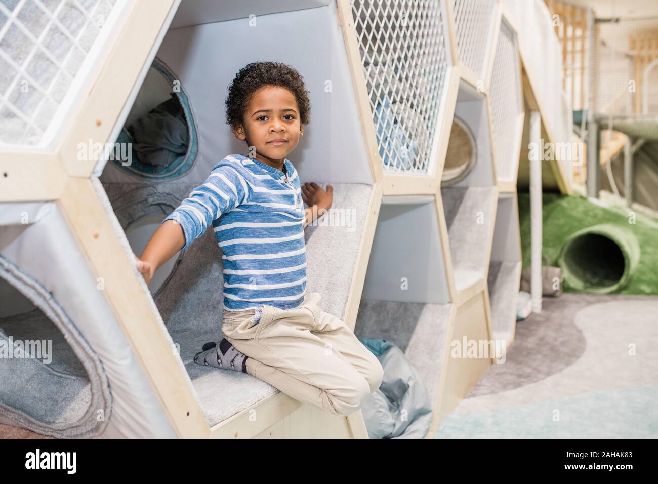 Adorable pre-elementary child of African ethnicity wearing shirt and jeans Stock Photo