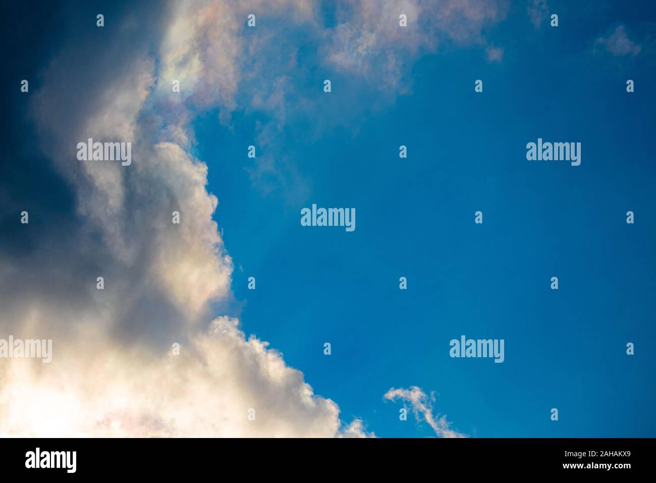 Dark clouds are making their way into a blue sky in this cloudscape. Stock Photo