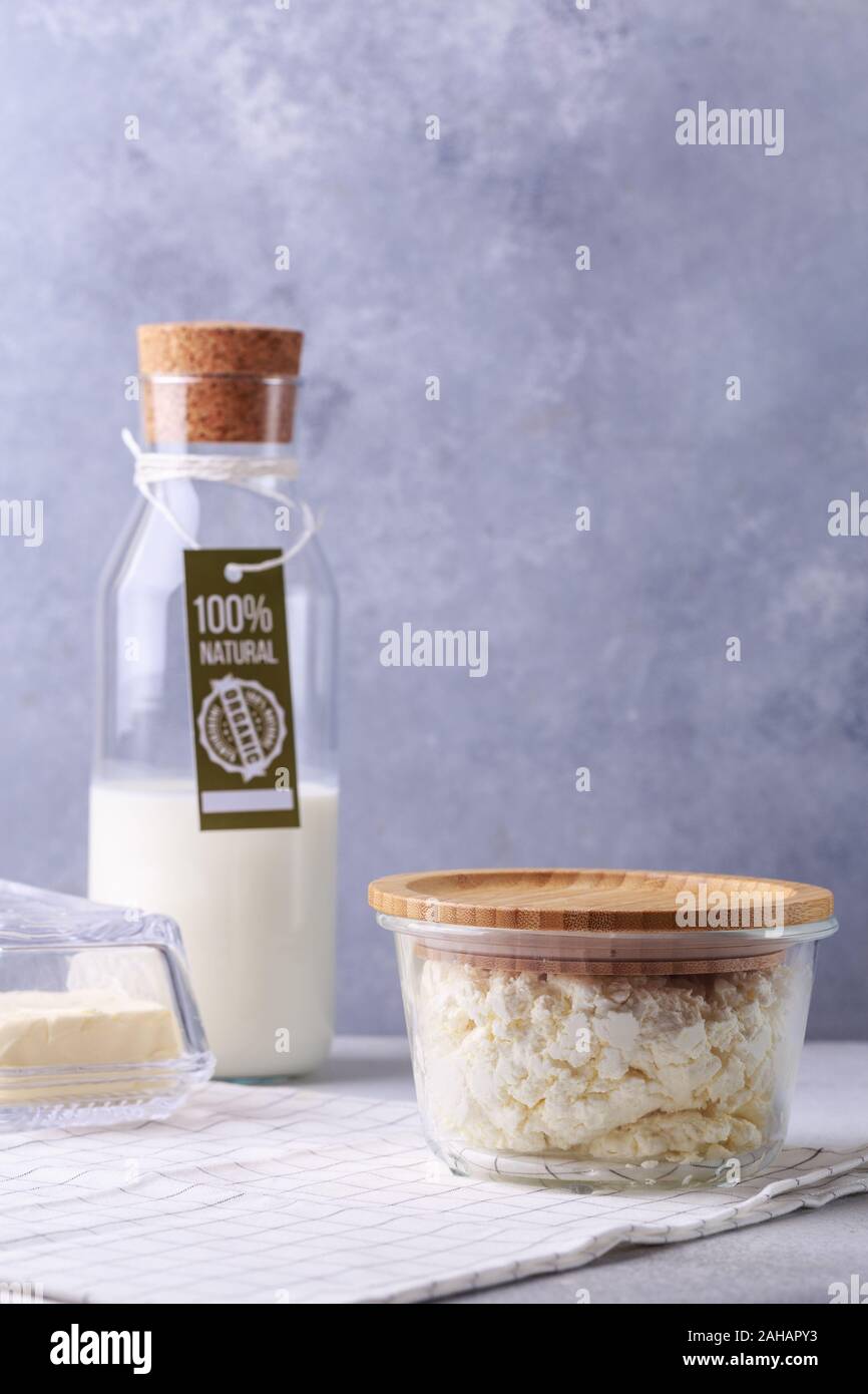 dairy products concept on grey bottle of milk with label natural products cottage cheese and butter Stock Photo