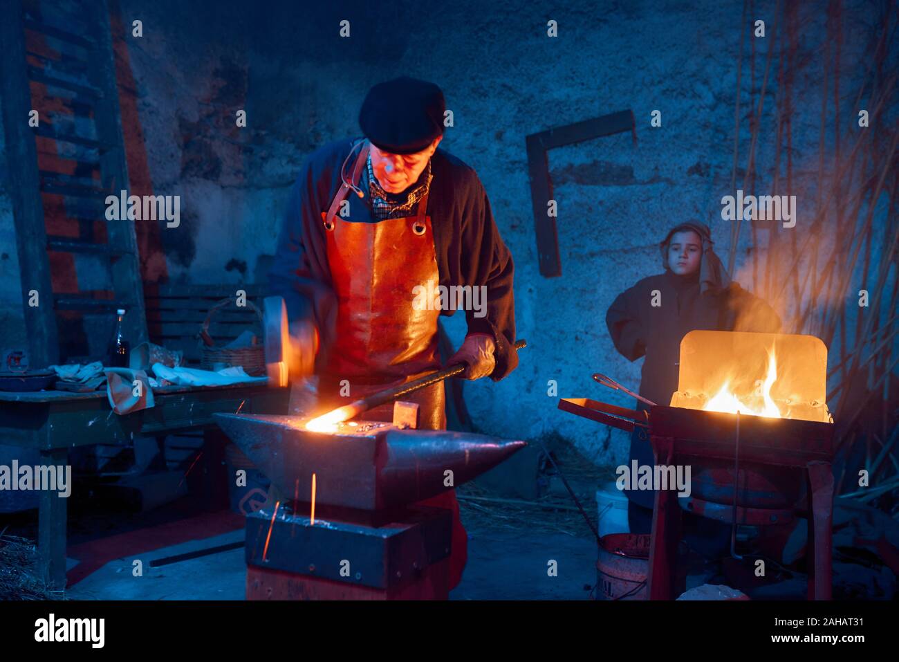 Italy, Sicily, Partinico, December 22/2019,beautiful living nativity scene in the Parrini district, blacksmith at work with his assistant Stock Photo