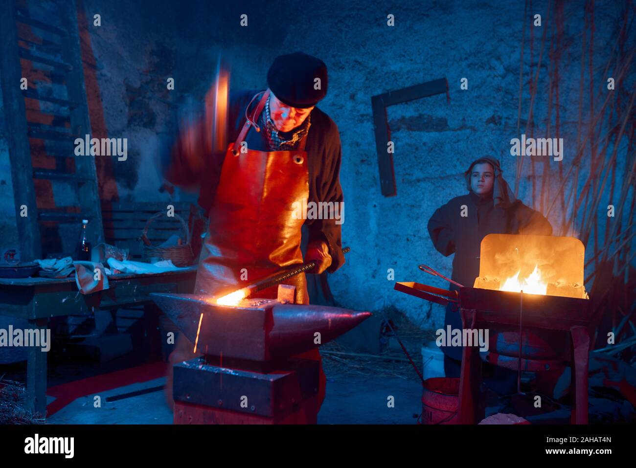 Italy, Sicily, Partinico, December 22/2019,beautiful living nativity scene in the Parrini district, blacksmith at work with his assistant Stock Photo