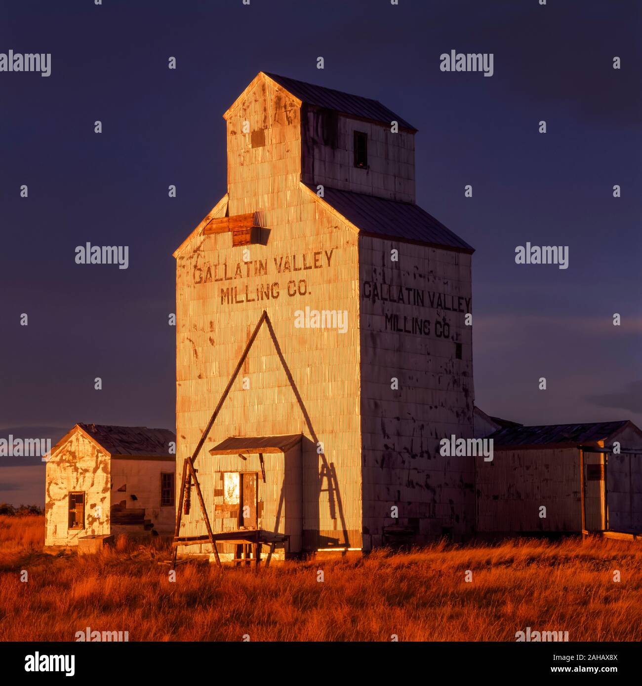 old grain elevator in evening light near choteau, montana Stock Photo