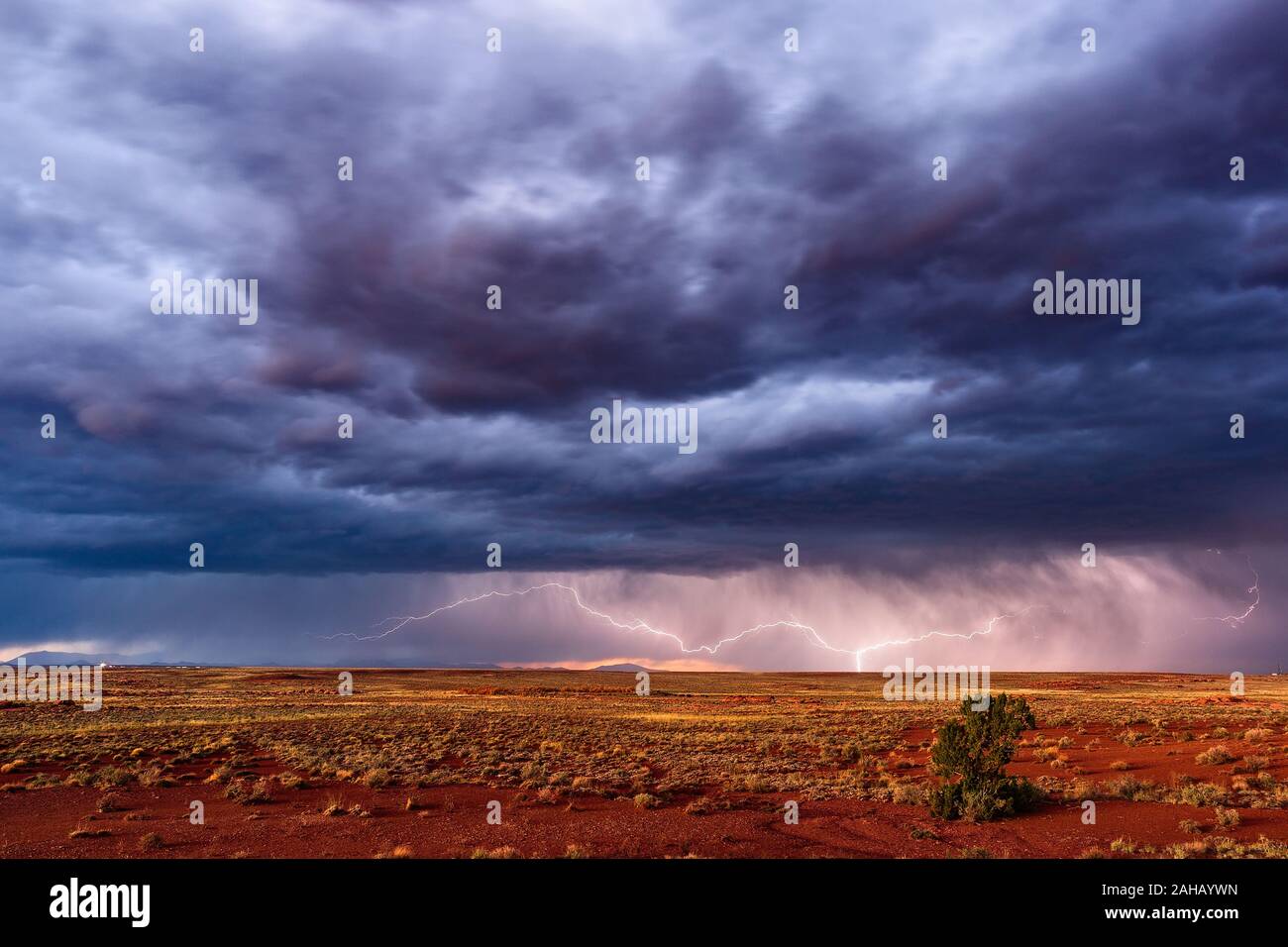 Distant thunderstorm with lightning and dramatic sky near Winslow, Arizona Stock Photo