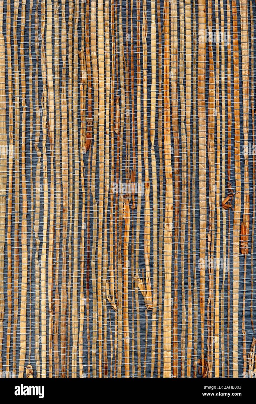Old wallpaper sample of natural grasscloth from the 1980s. This paper