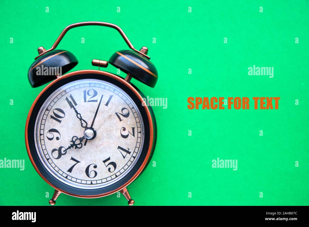 Old, vintage retro alarm clock on a bright green background Stock Photo
