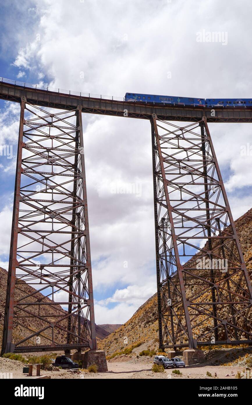The historic Tren a las Nubes (Train to the Clouds) crosses the Polvorilla Viaduct near San Antonio de Los Cobres, in the high altitude puna desert of Salta province in northern Argentina Stock Photo
