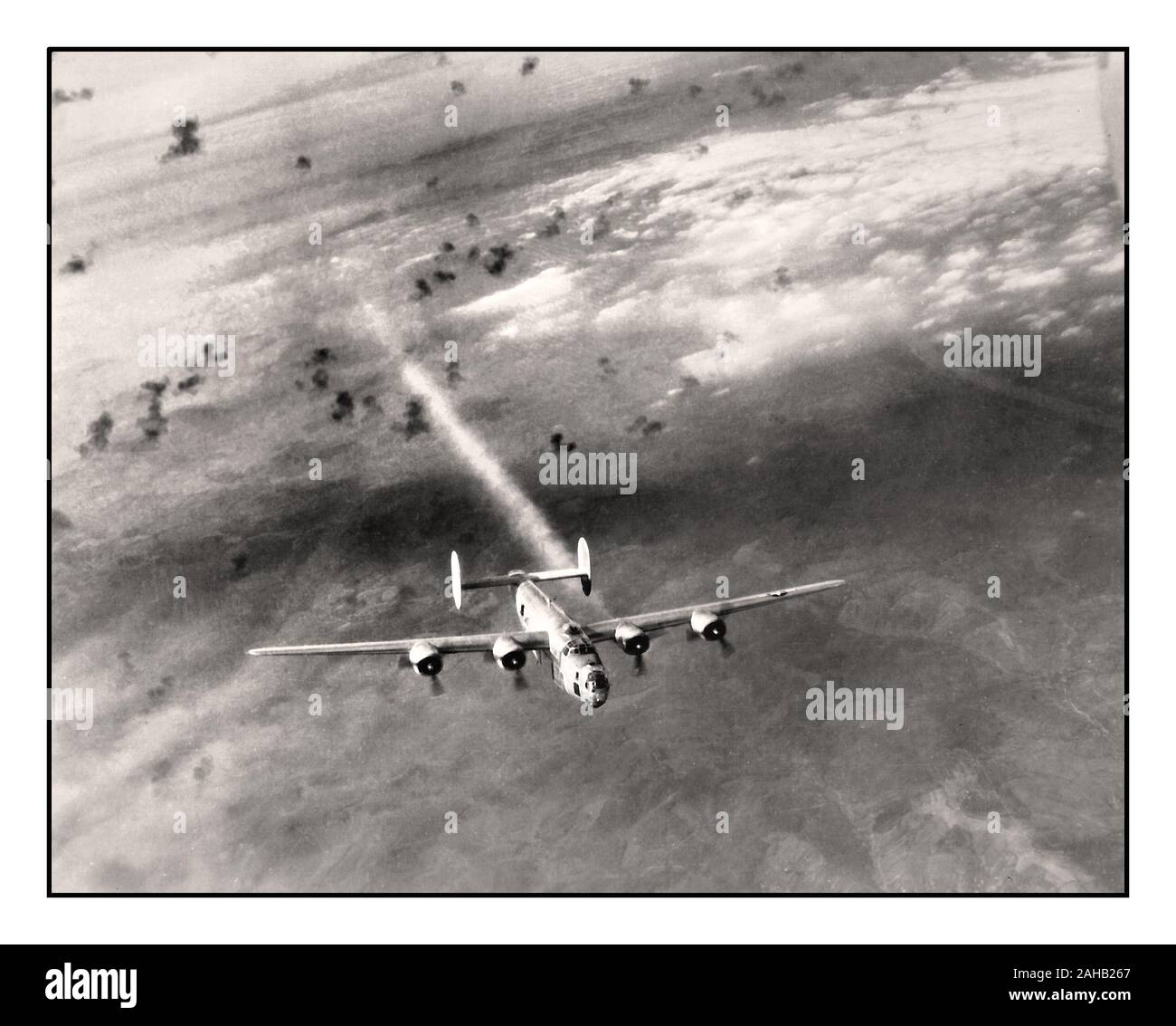 B-24H Bomber Aircraft Flak World War II Aerial image of American Airforce bomber flying through a barrage of flak, returning from Vienna, Austria, B-24H Liberator “Scrappy” with the 725th Bomb Squadron trails smoke and is losing altitude east of Zagreb 1940's Stock Photo