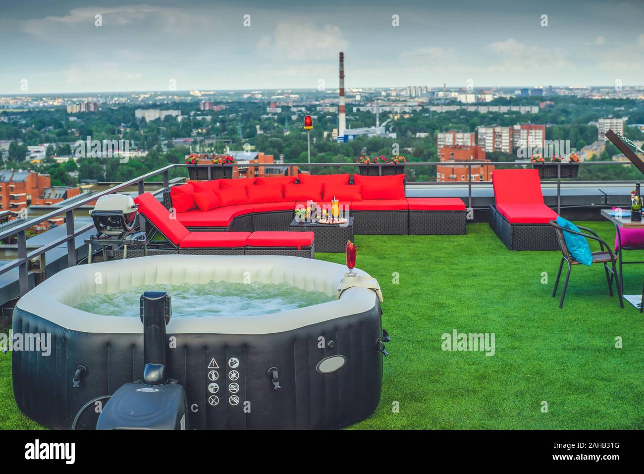 Outdoor jacuzzi in relax zone on the rooftop terrace in modern living