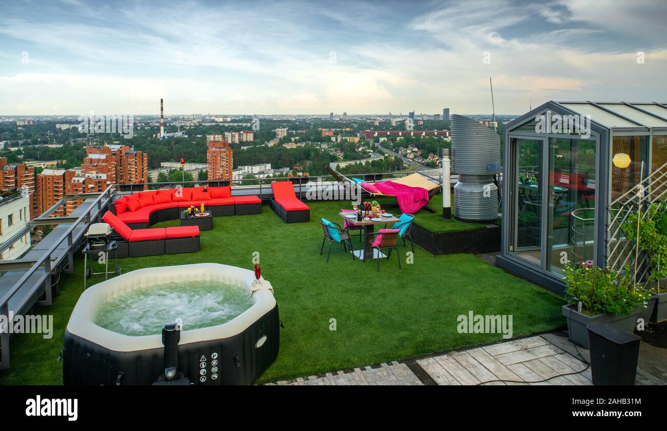Outdoor jacuzzi in relax zone on the rooftop terrace in modern living