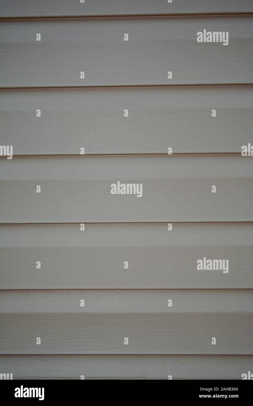 Here are some horizontal running wooden house siding panels in a creme