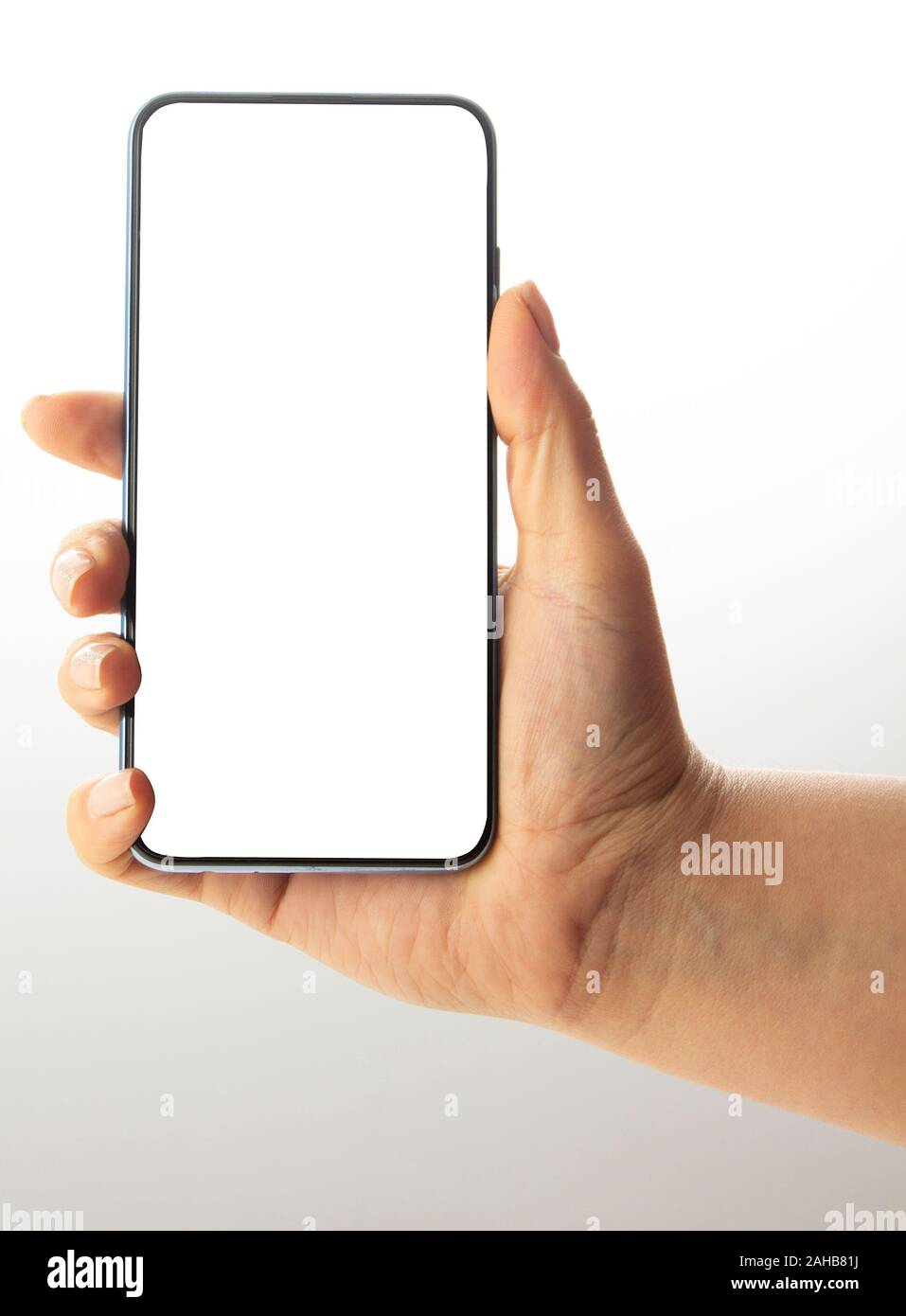 Hand holding black Smartphone with blank screen on white background ...