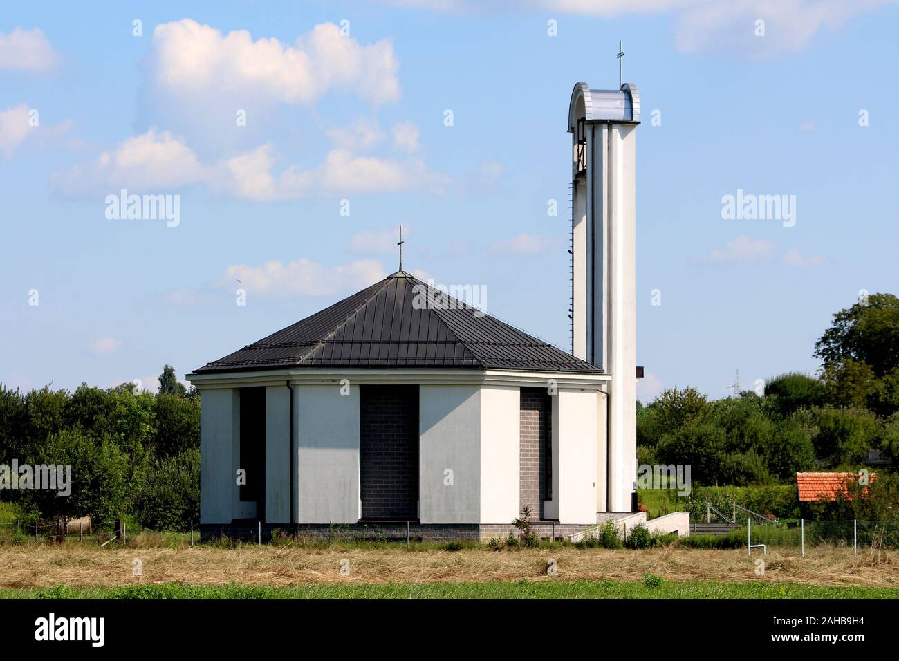 Side view of modern unusually built white and grey catholic church with
