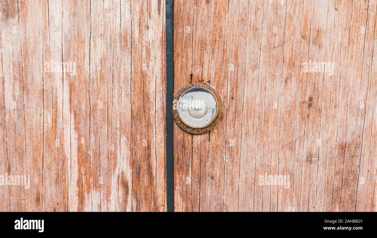Vintage wood door with peep hole viewer background texture Stock Photo